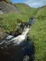 a small burn runs down to the beach and makes interesting and peaty pools